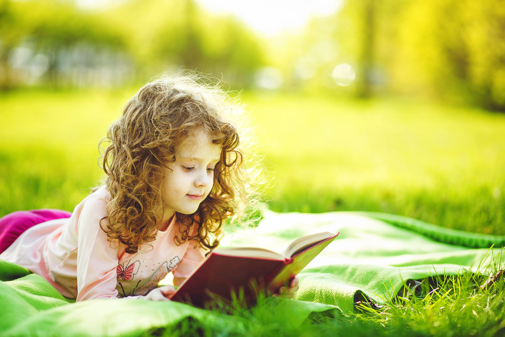 girl reading in grass